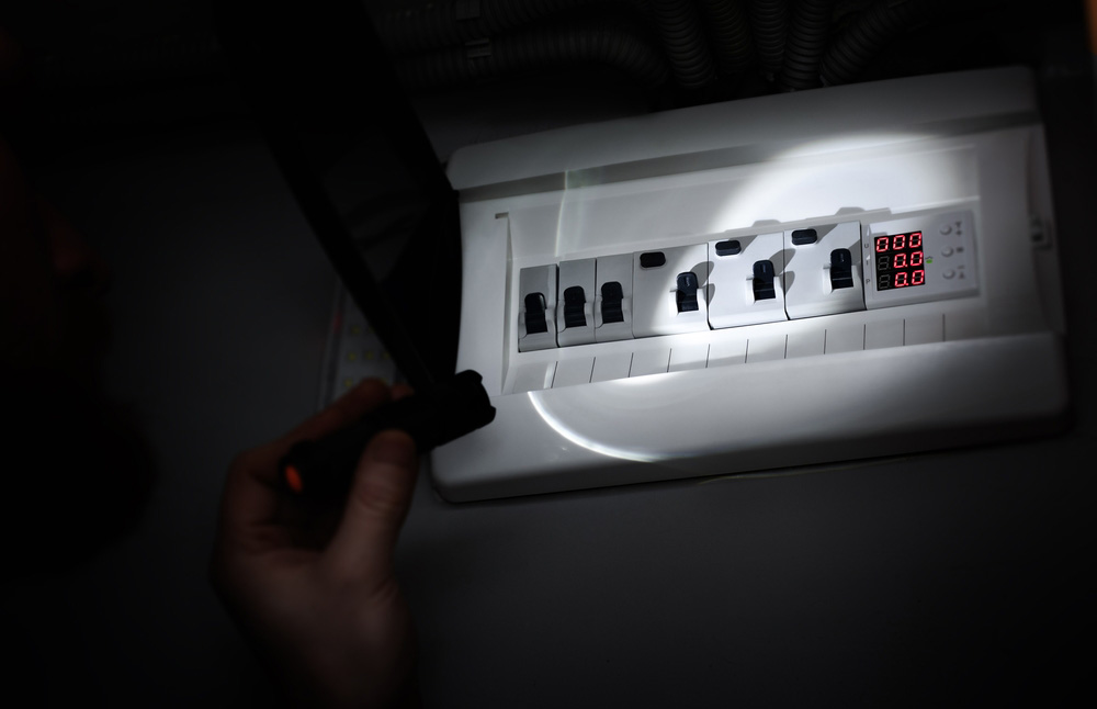 flashlight being shone on a breaker flashlight being shone on a breaker