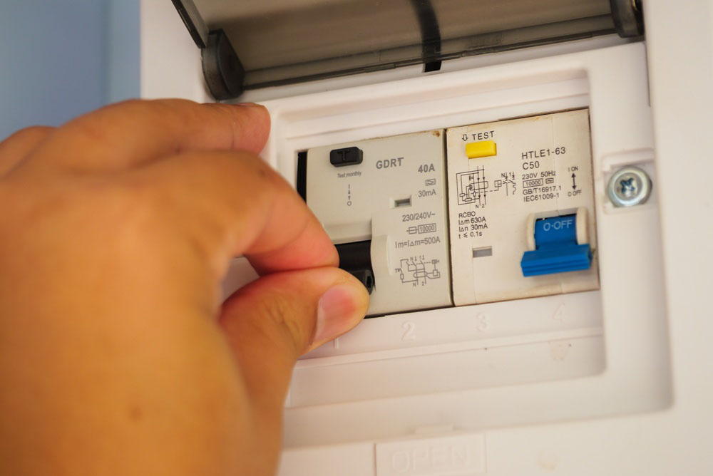 person resetting a breaker