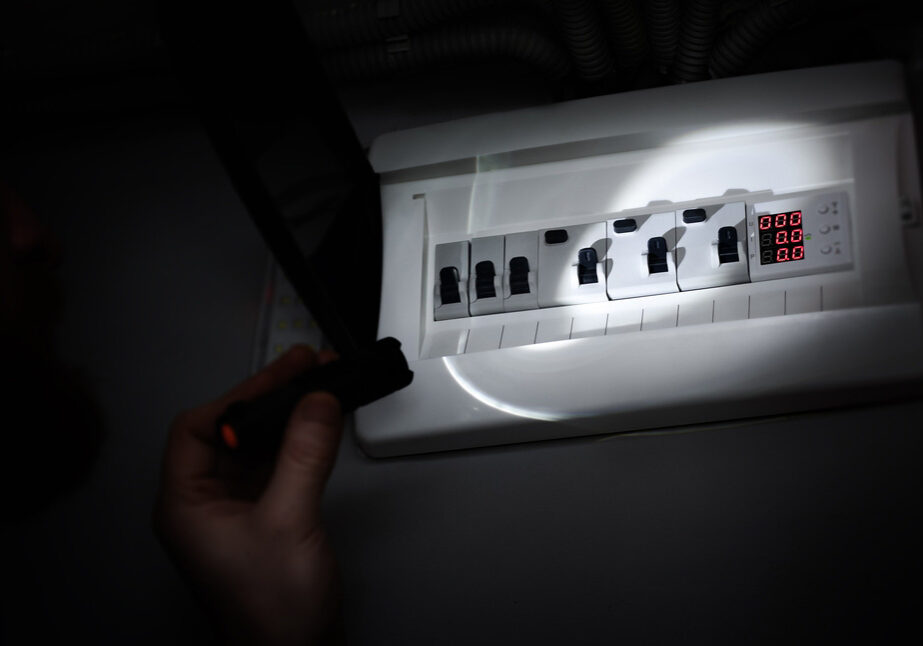 flashlight being shone on a breaker